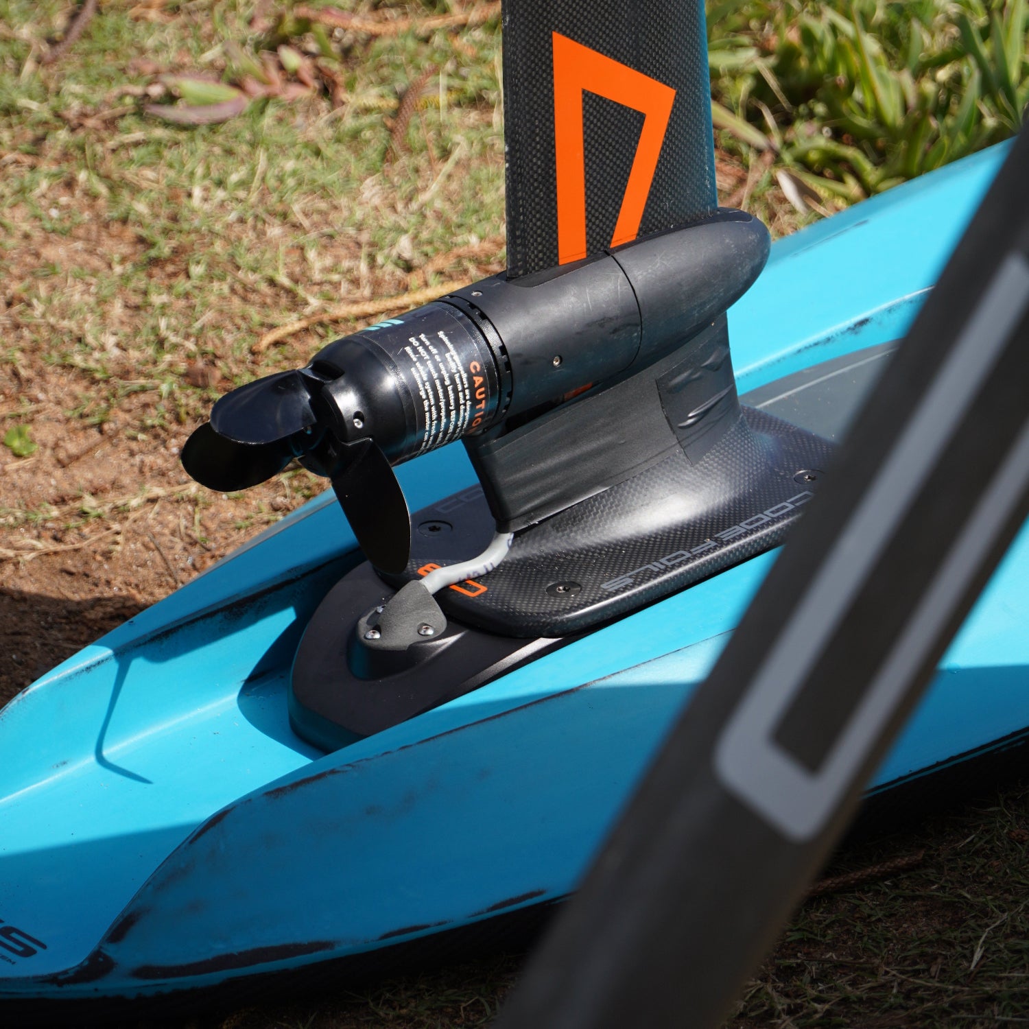 Close up shot of the Foil Drive assist kit equipped on a Kruzer RTS Foil Drive board foilboard by Amos Shapes