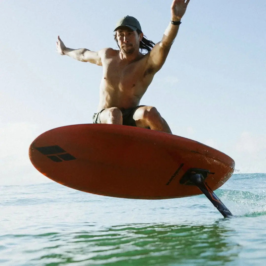 Amos Shapes KrUzer V2 rider Josh Ku on wave surf foiling with carbon foilboard in action