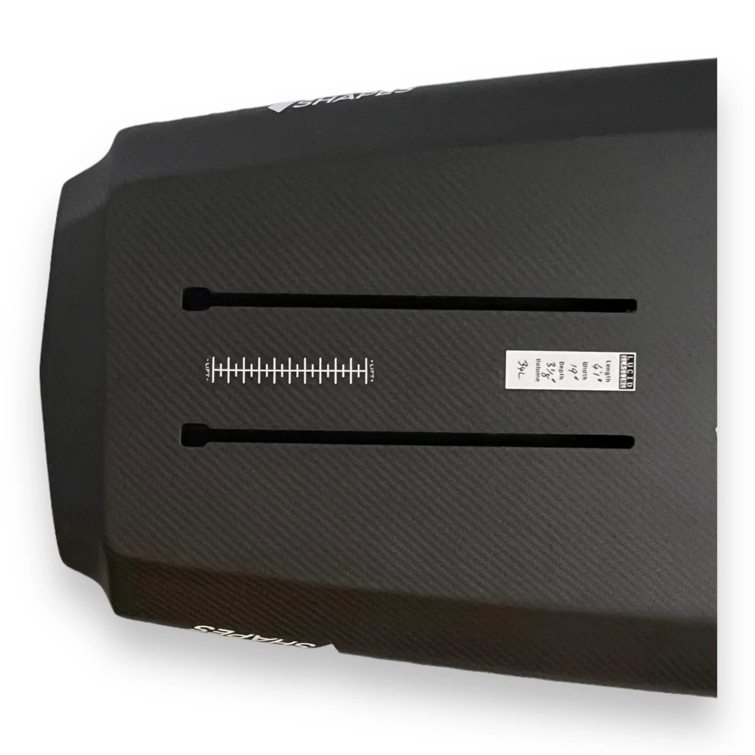 Bottom view of the tail of a black Nano Prone carbon foilboard by Amos Shapes showing its hydrofoil tracks