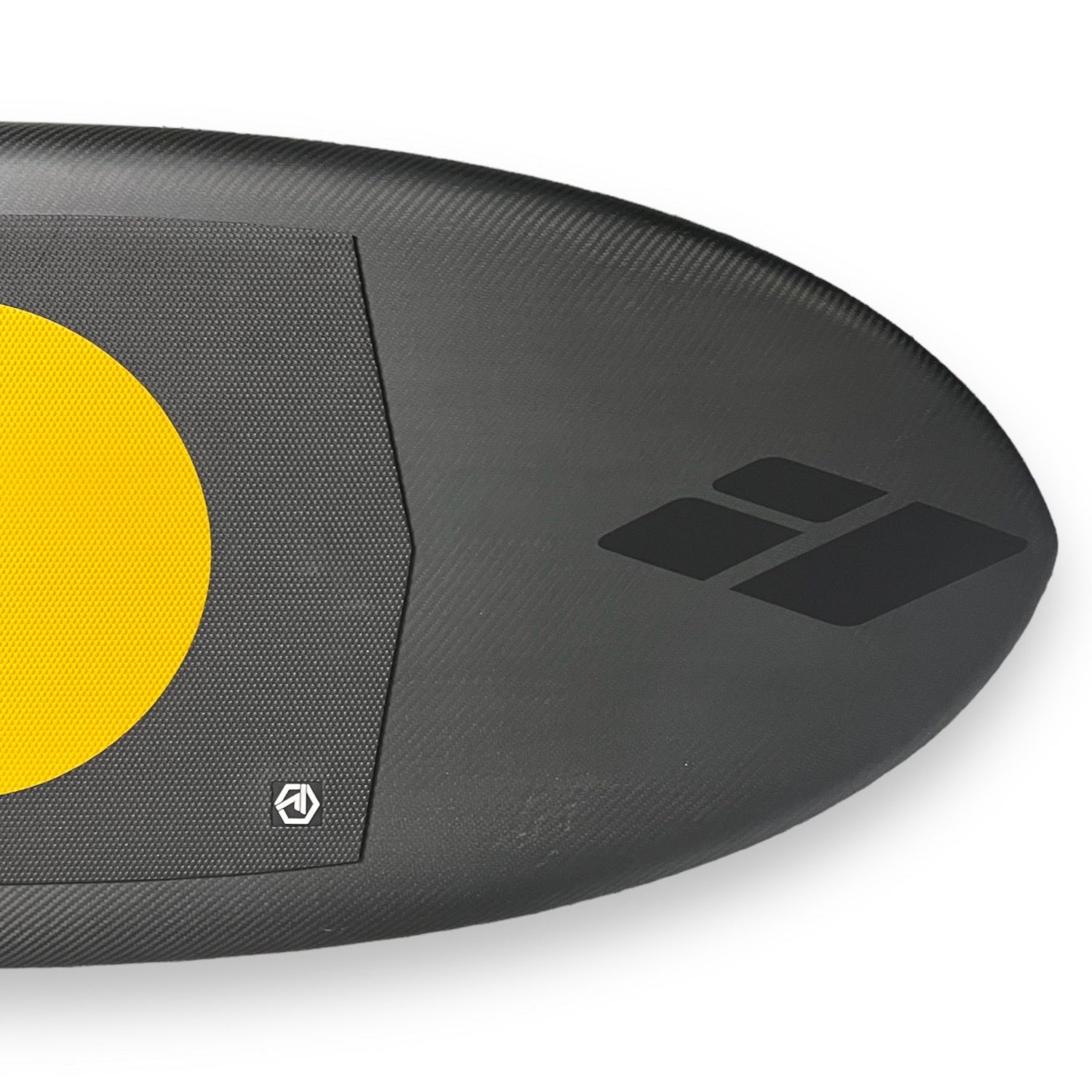 Close up shot of the nose of a black Kruzer prone carbon foilboard by Amos Shapes with the black Amos Shapes logo and a Josh Ku Honey Comb traction pad on it