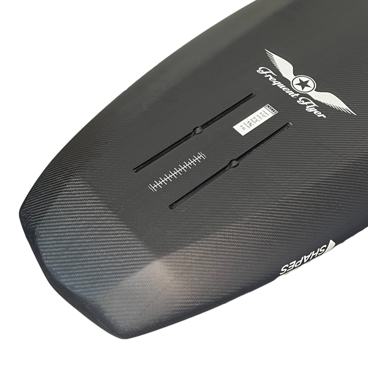 Close up view of the tail of a black Amos Shapes Frequent Flyer beginner prone carbon foilboard with a white Frequent Flyer logo and showing its hydrofoil tracks