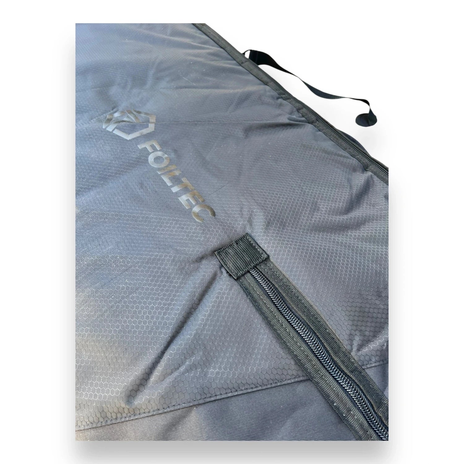 Foil Tec logo and zipper on top of a black foilboard travel bag